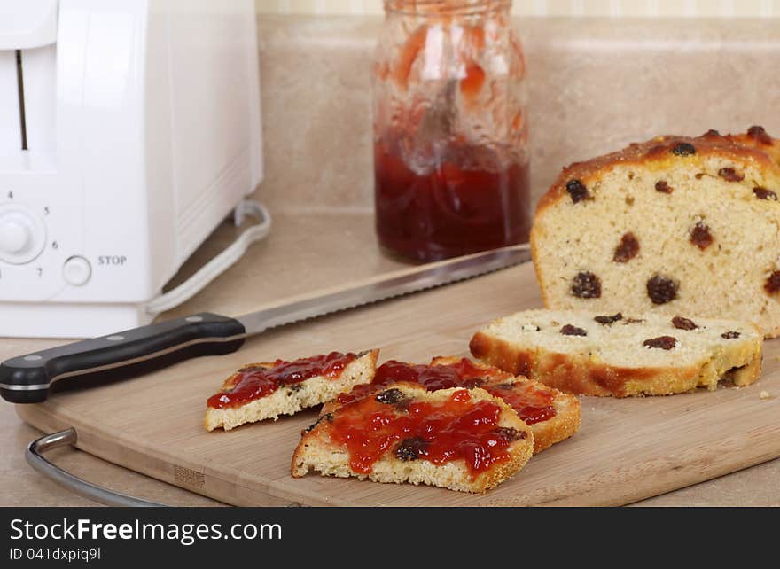 Raisin bread with toasted slices with jam on a cutting board