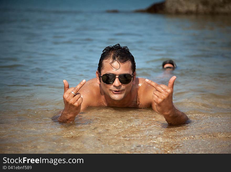 A Handsome and Funny guy showing Gestures related to fun he's having. A Handsome and Funny guy showing Gestures related to fun he's having