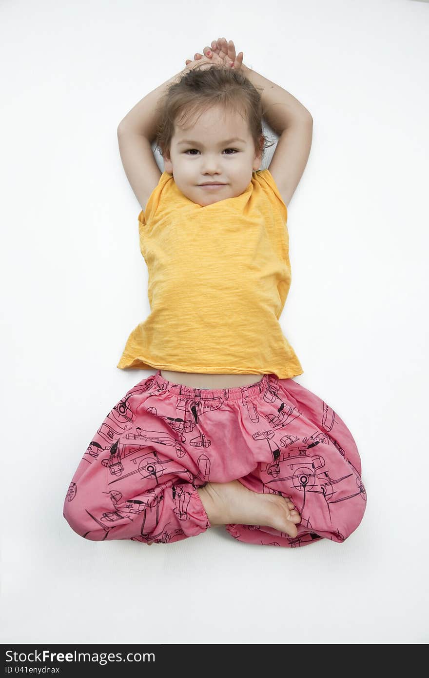 Three year old girl in the pose of the Buddha