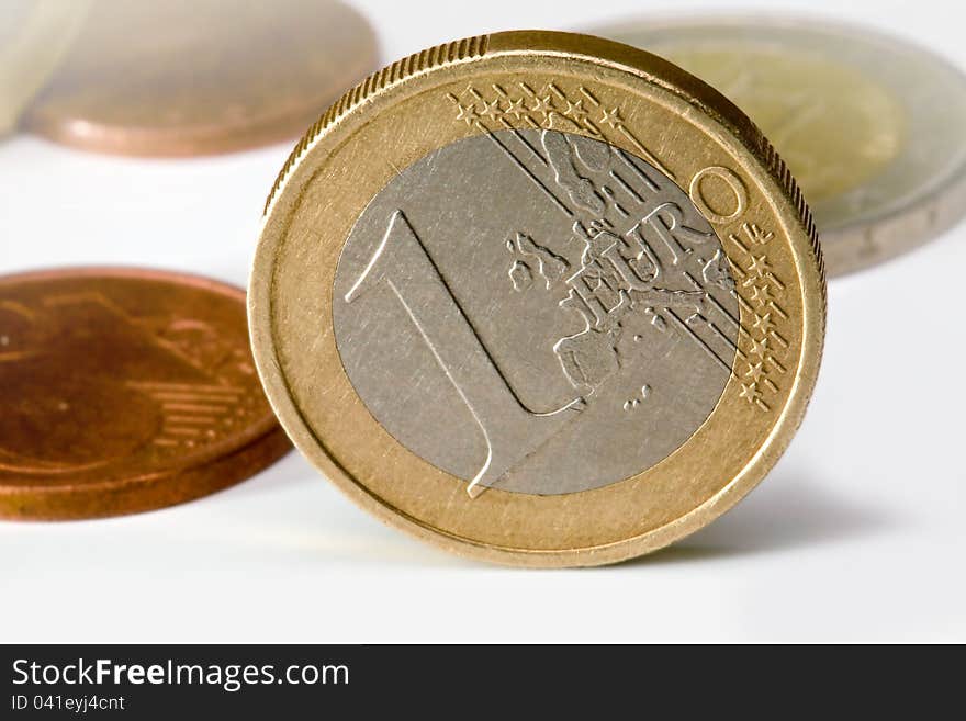 One euro coin of other coins in background