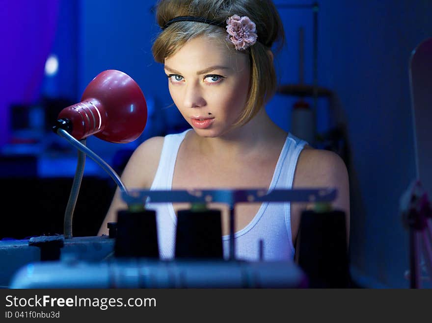 Seductive blond sewing in her workshop