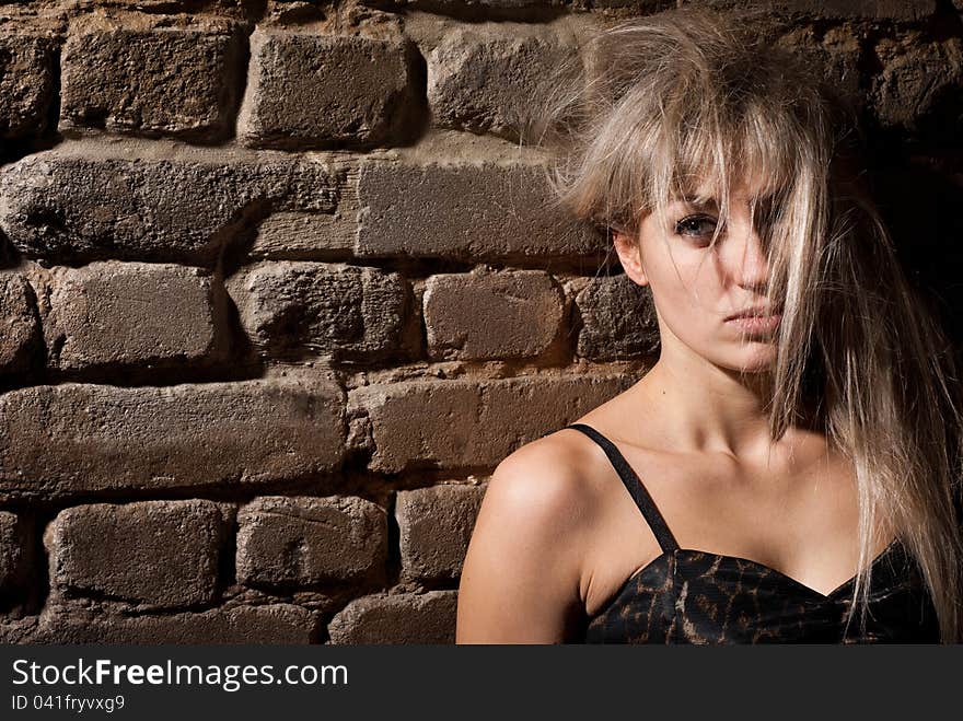 Portrait of girl at a brick wall