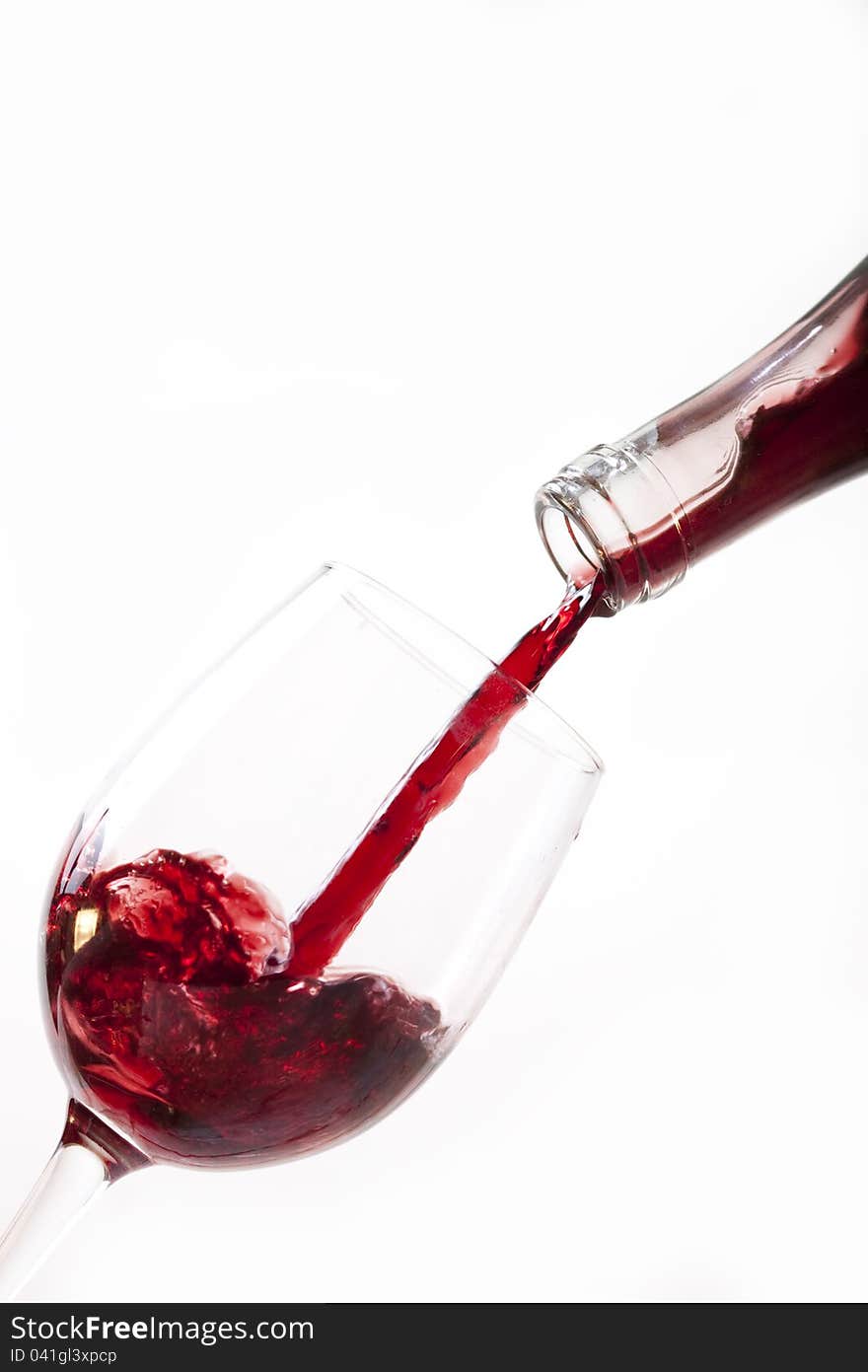 Red wine pouring into glass