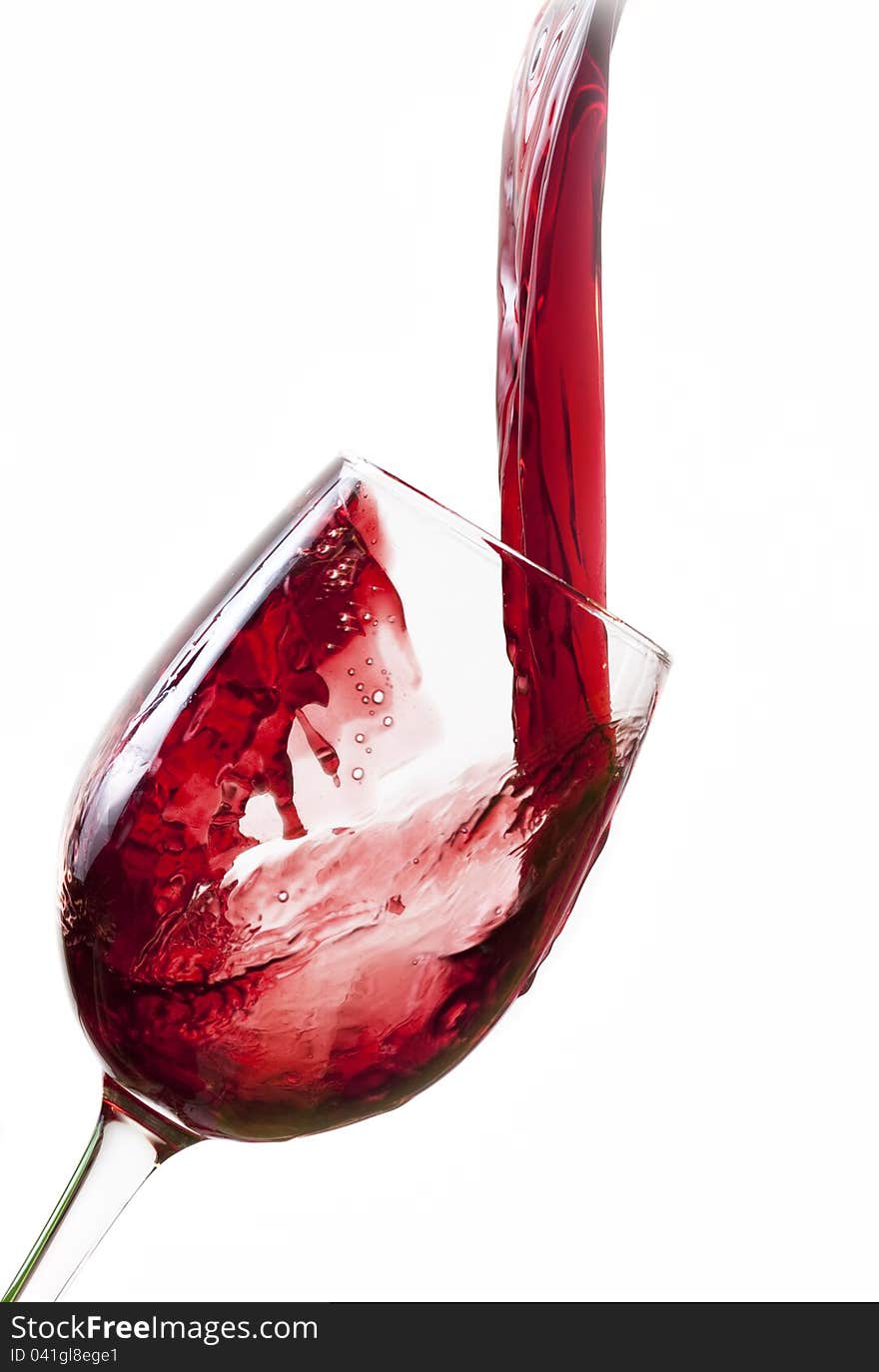 Red wine pouring into glass