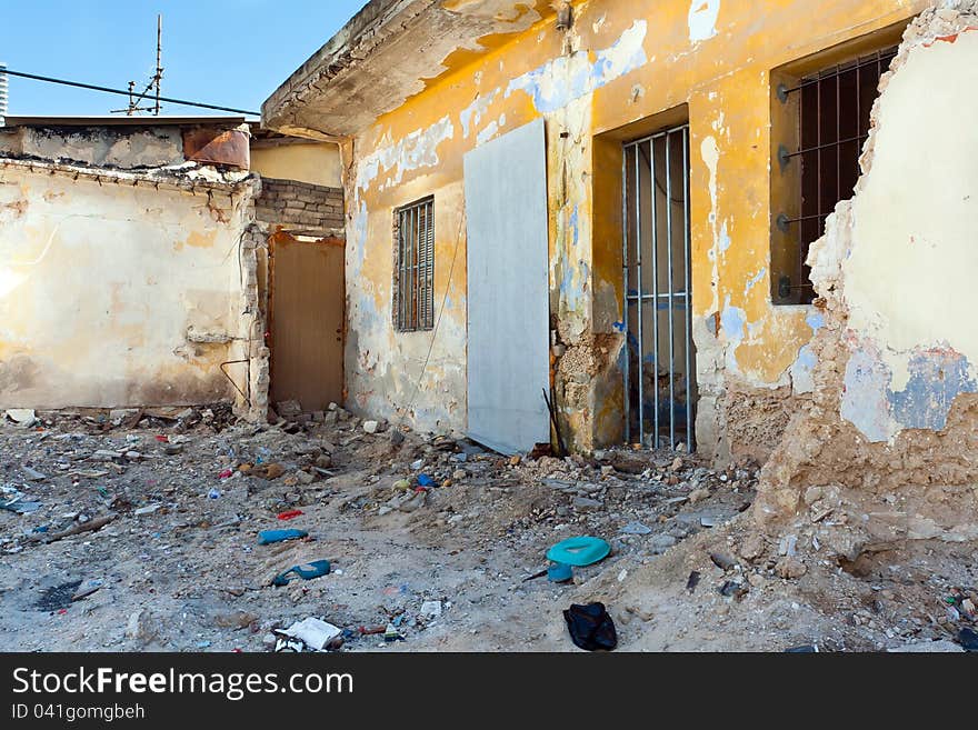 The old destroyed house and trash around