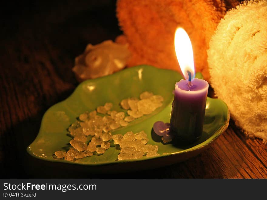 Sea salt, towel and burning candle. Sea salt, towel and burning candle