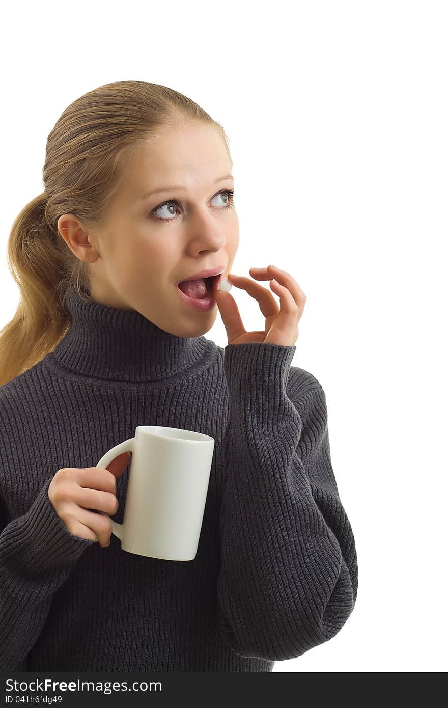 A beautiful young woman taking a tablet on a white background