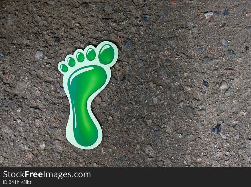 Close-up portrait of sign of human foot prints on the gray asphalt. Close-up portrait of sign of human foot prints on the gray asphalt