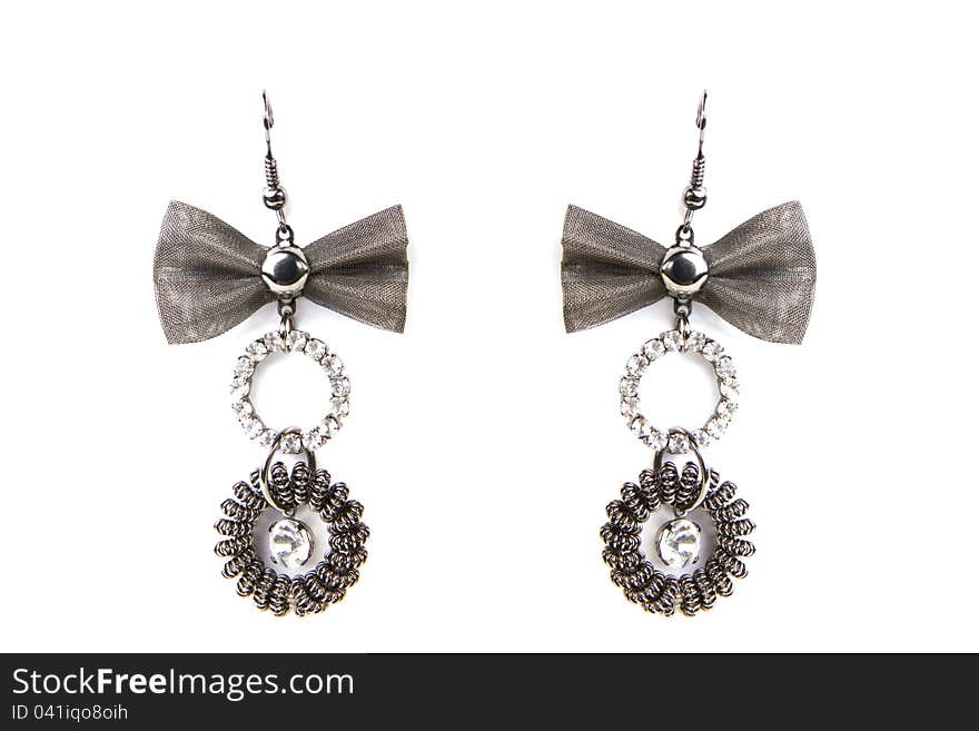 Earrings with rings and bow on white background