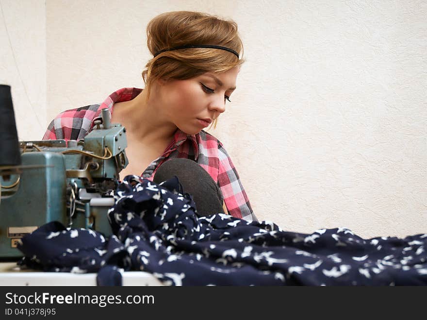 Woman Seamstress Posing Near Sewing Machine