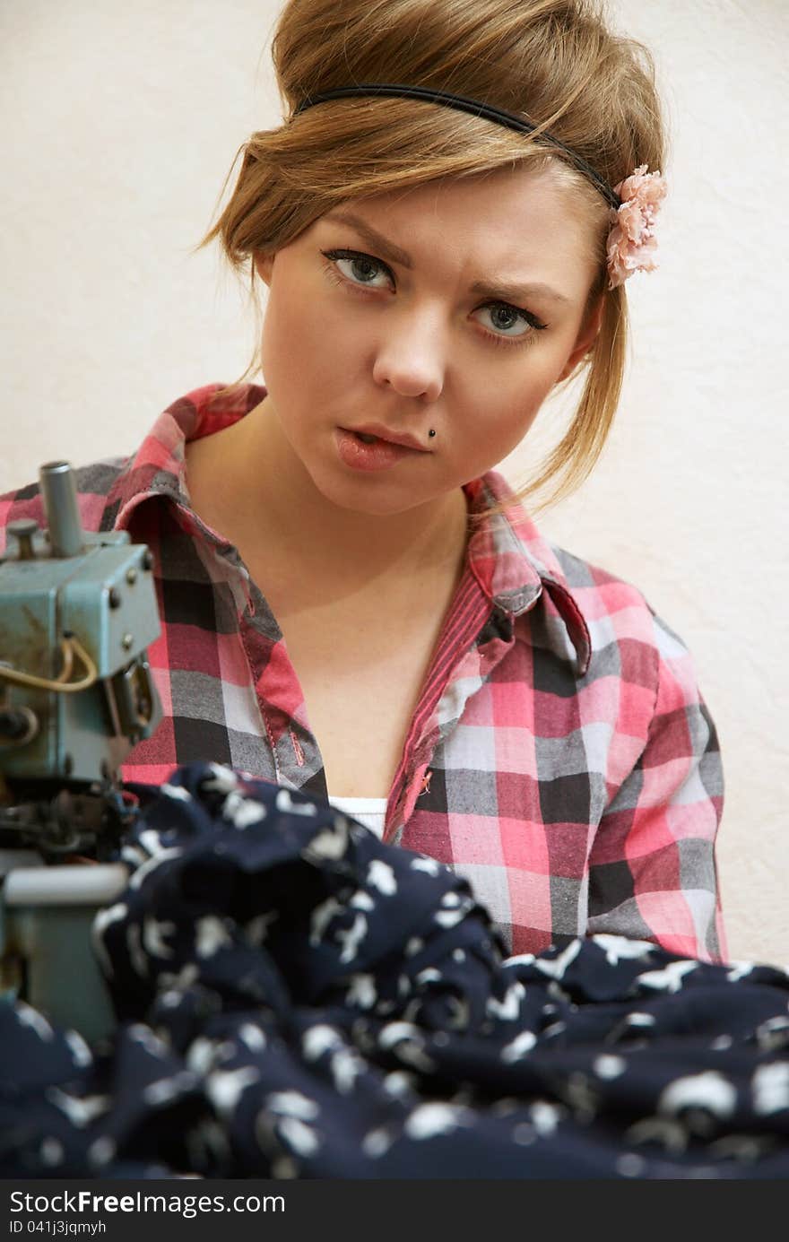 Woman Seamstress Posing Near Sewing Machine