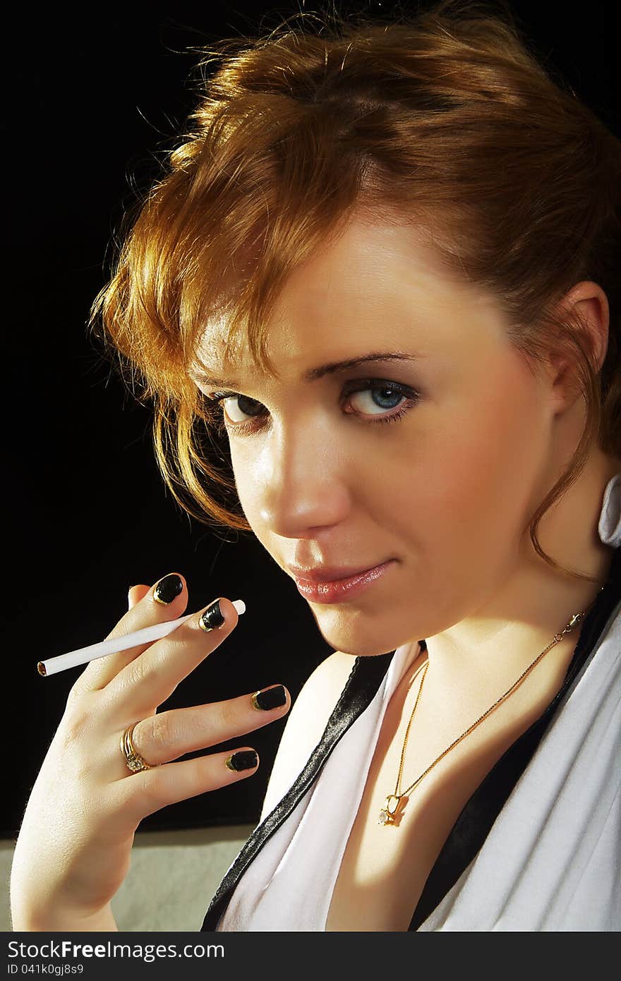 Beautiful woman with cigarette on dark background