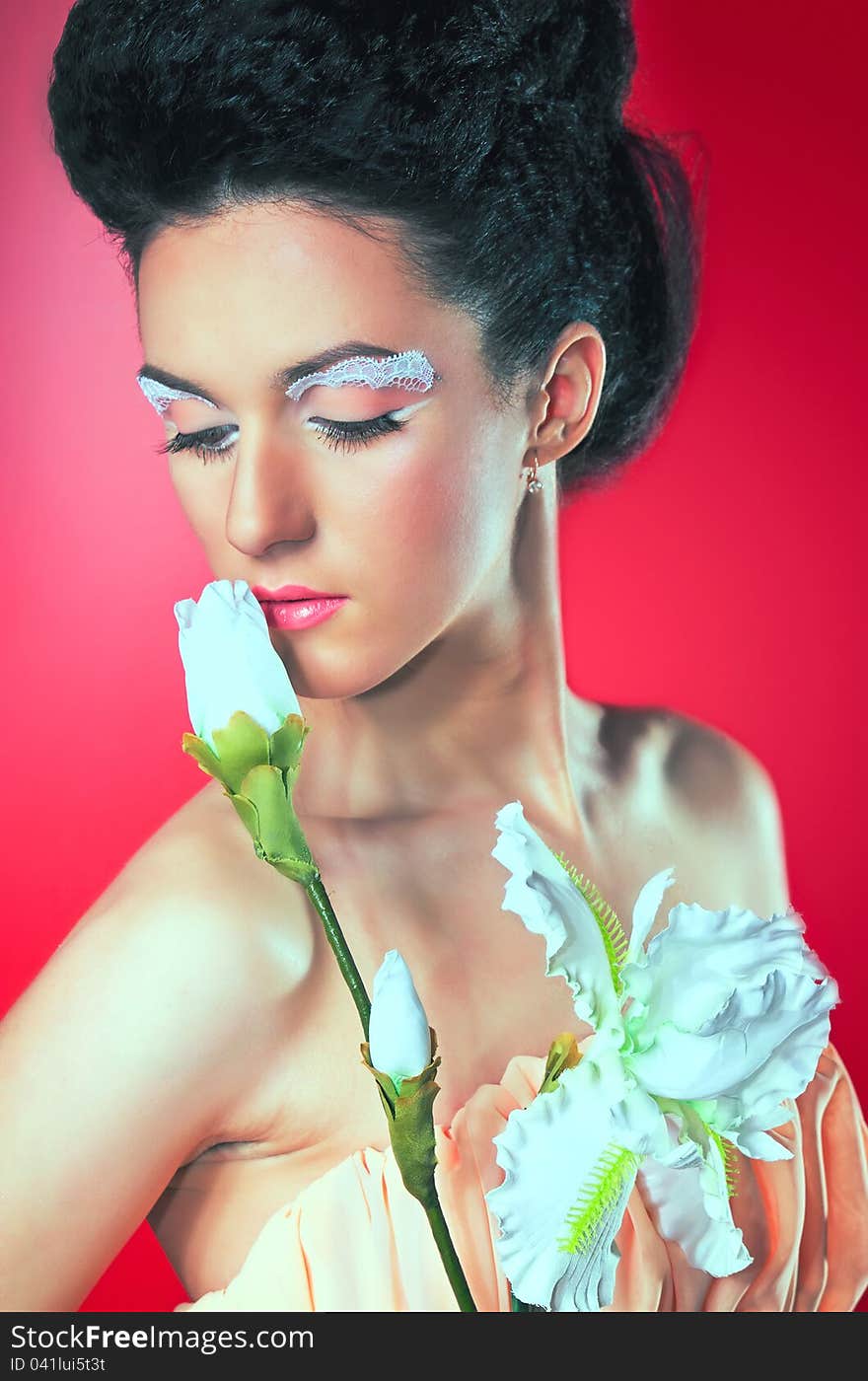 Beautiful woman with flower on a red