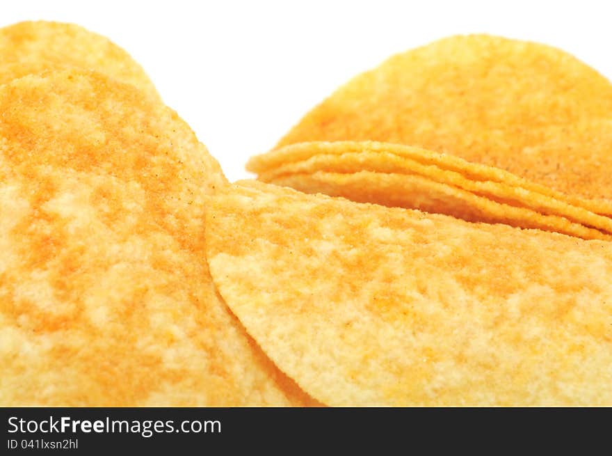 A close-up shot of potato chips (crisps) on a white background. A close-up shot of potato chips (crisps) on a white background