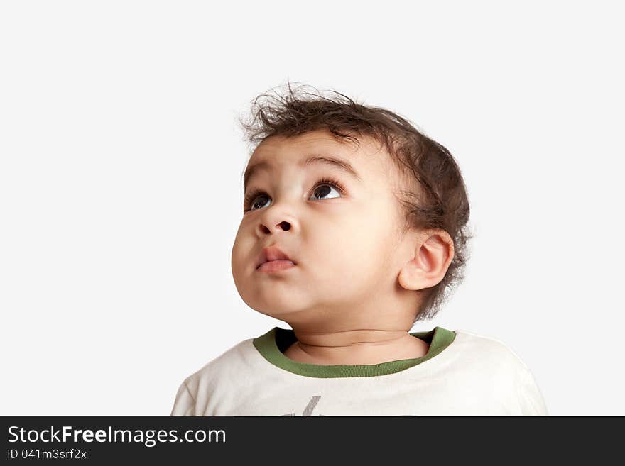 Curious indian kid looking at the camera on white background. Curious indian kid looking at the camera on white background.