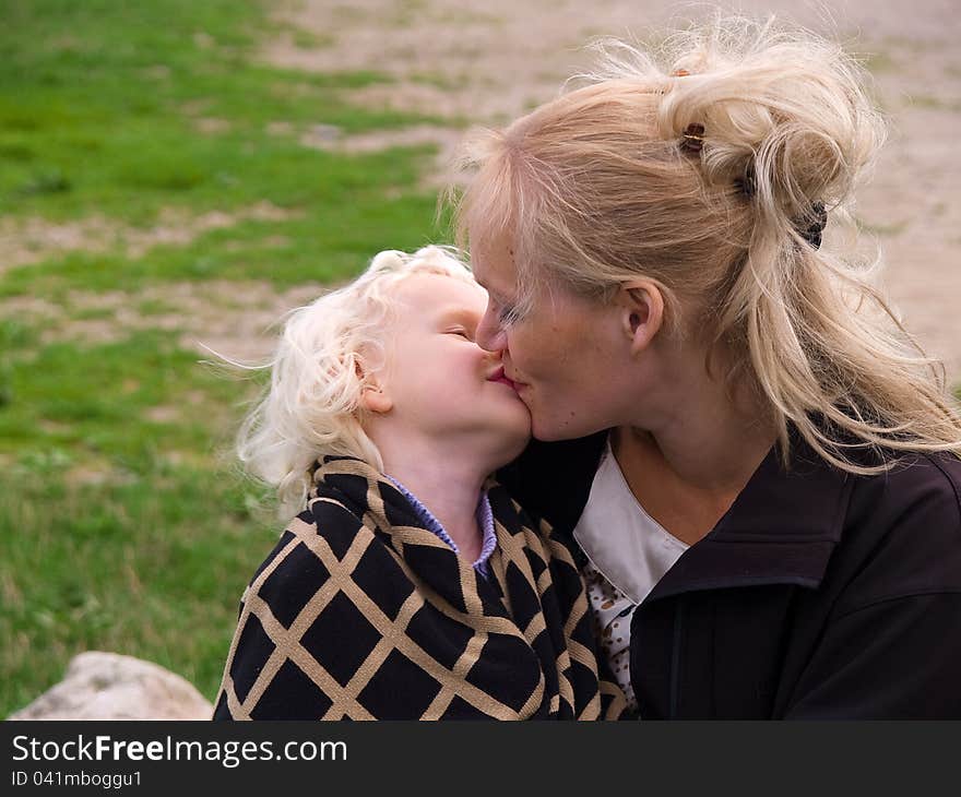 Close Up Of Affectionate Mother And Daughter hugging outdoors in nature