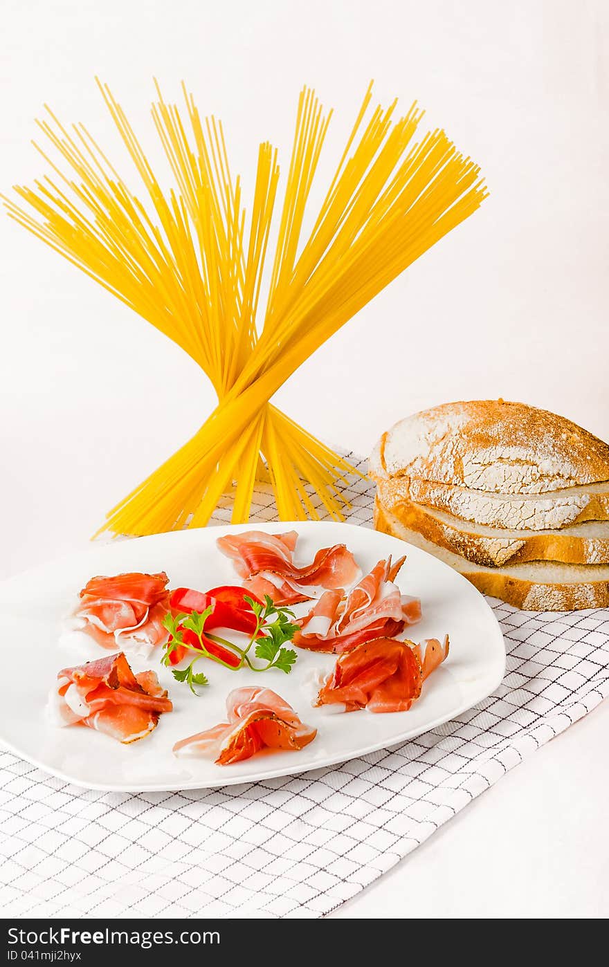 Italian prosciutto appetizer with pasta and italian bread.