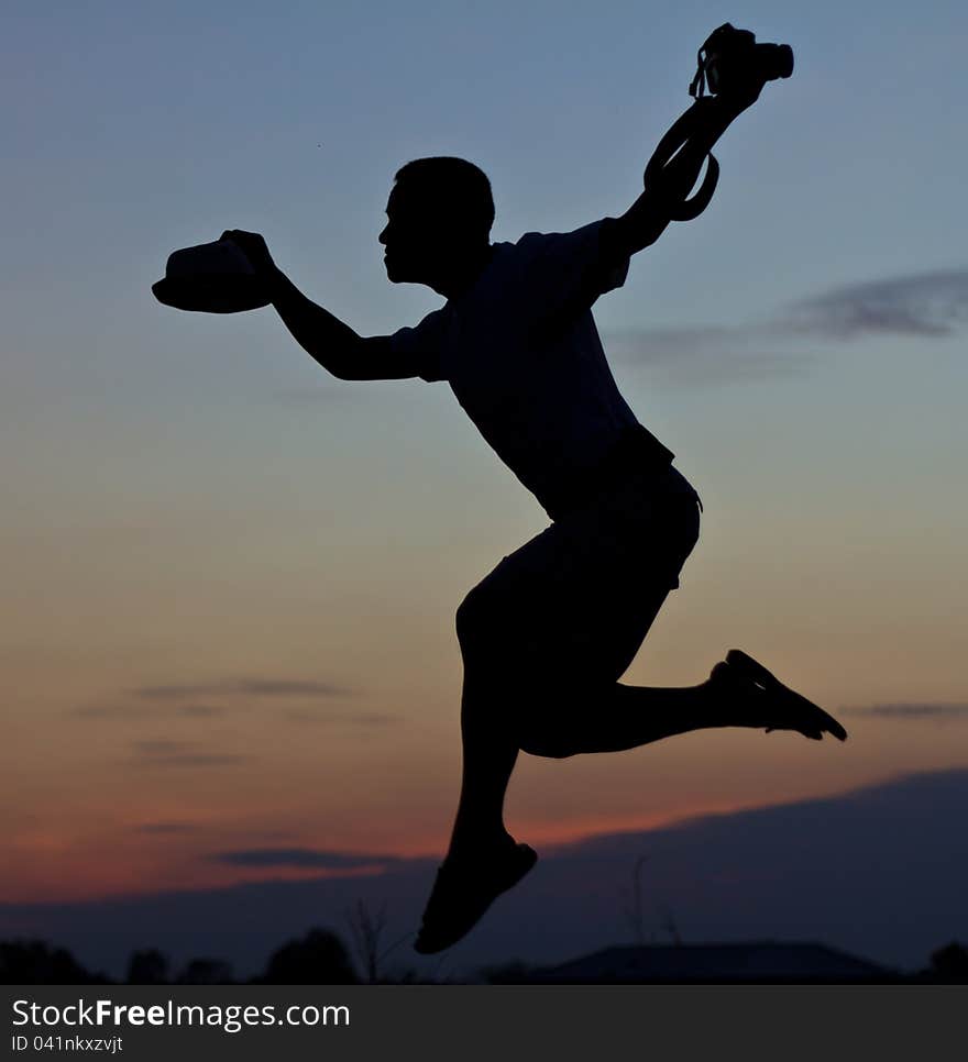 Photographer silhouette relax by jumping in the air. Photographer silhouette relax by jumping in the air.