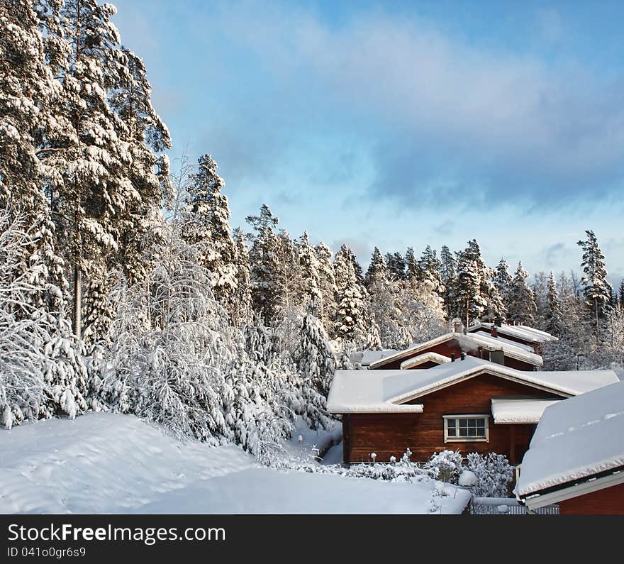 Log Houses In Snowy Winter Scenery