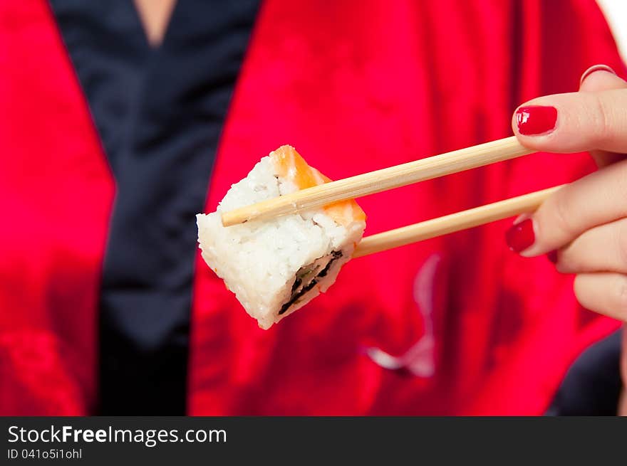 Sushi girl holds two sticks