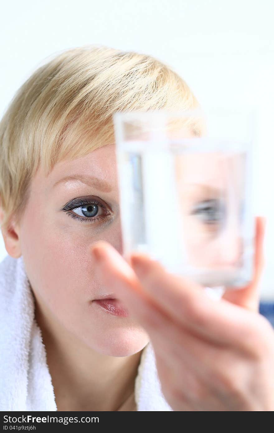 Image of a woman looking at a glass of water