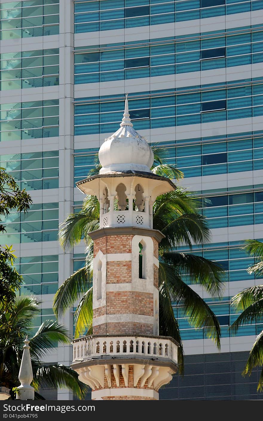 Minaret of mosque with abstract building background
