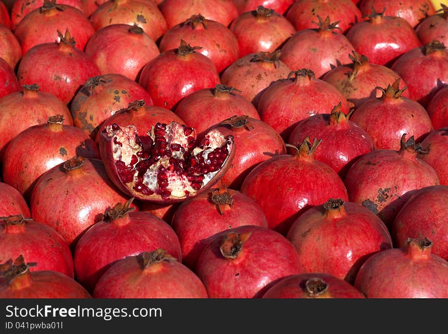 The background of the laid out mature grenades bright red. The background of the laid out mature grenades bright red