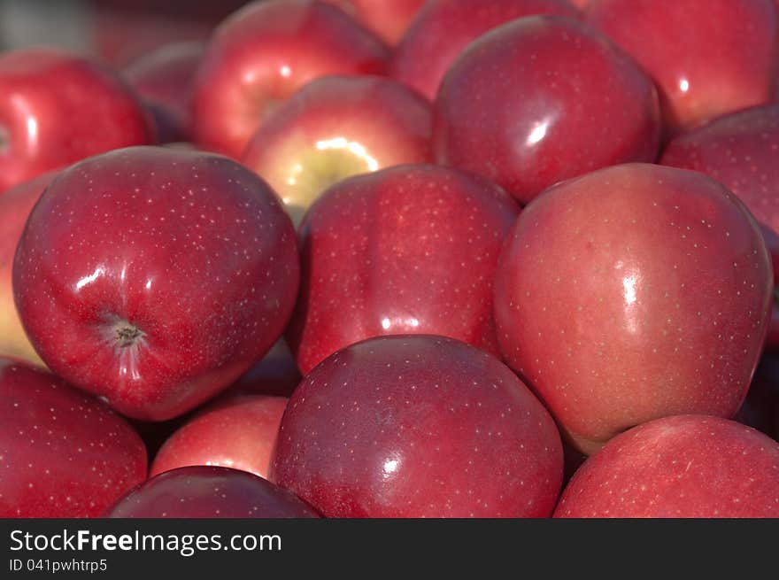 Red apples on the counter for sale.