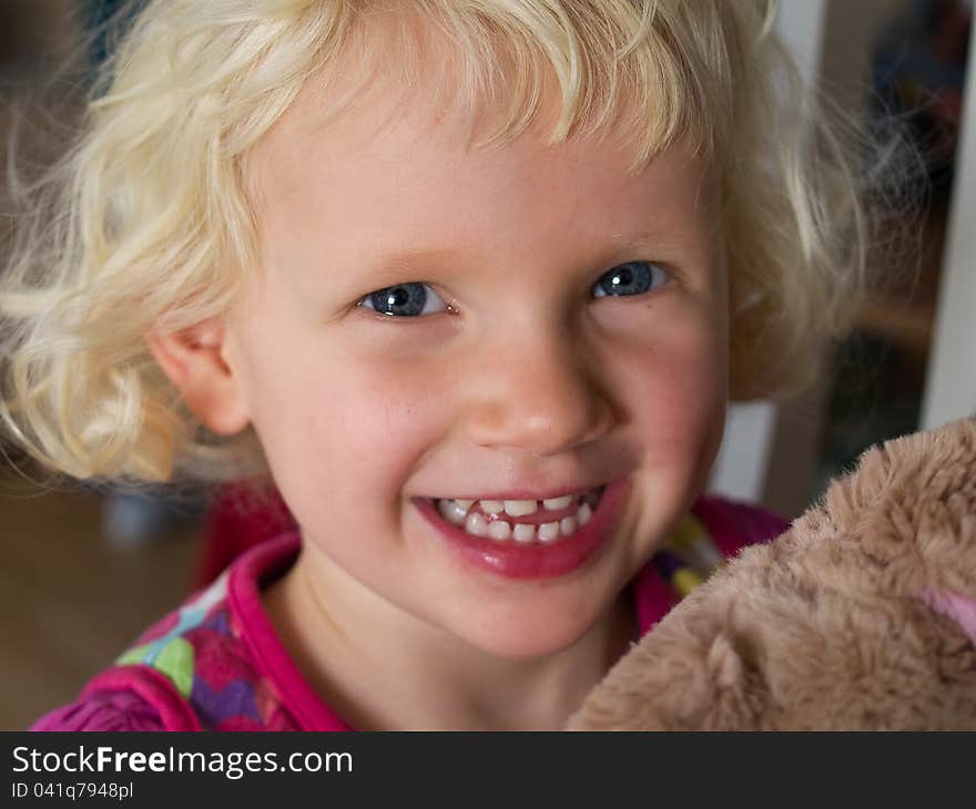 Smiling beautiful little girl with her teddy bear just before bed time. Smiling beautiful little girl with her teddy bear just before bed time