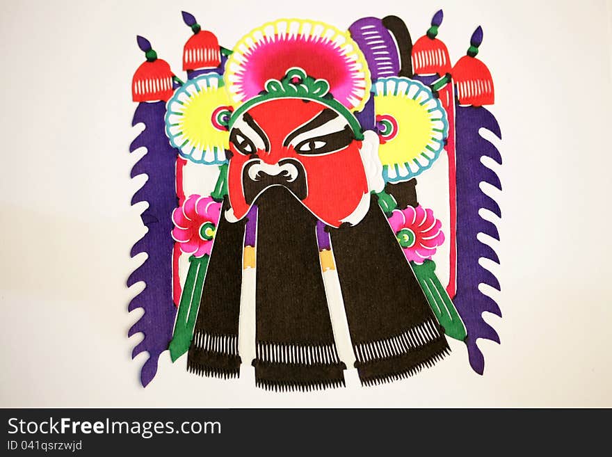 Paper-cutting is a traditional Chinese folk art. Paper-cut of a Peaking Opera Mask. Paper-cutting is a traditional Chinese folk art. Paper-cut of a Peaking Opera Mask