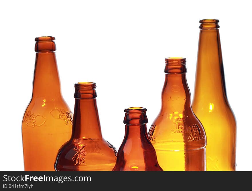 Image of empty brown beer glass bottles over white background