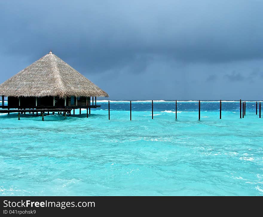 Small bungalows nestle on stilts above the ocean. It seems that in the event of a storm, it simply will take to the ocean. But it only seems so. Small bungalows nestle on stilts above the ocean. It seems that in the event of a storm, it simply will take to the ocean. But it only seems so.