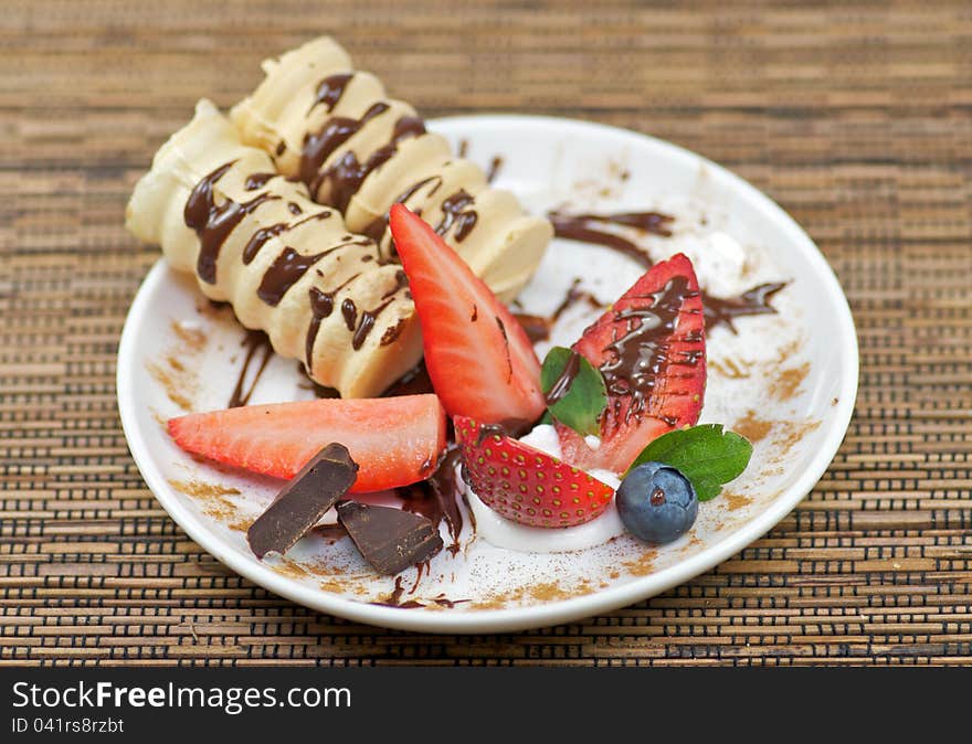 Delicious dessert with whipped creme and strawberry decorated chocolate. Delicious dessert with whipped creme and strawberry decorated chocolate