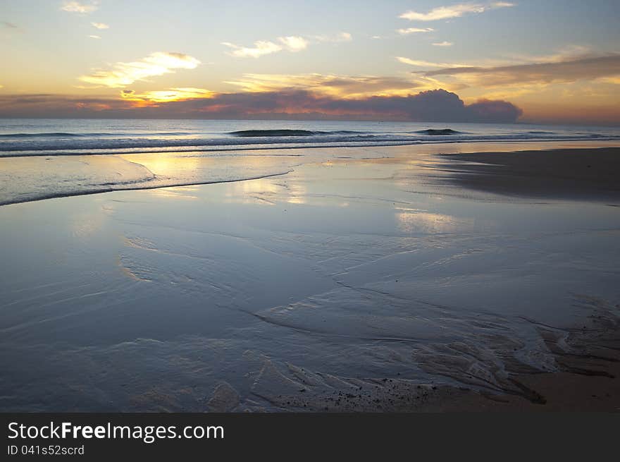 Sunrise on the ocean with reflections