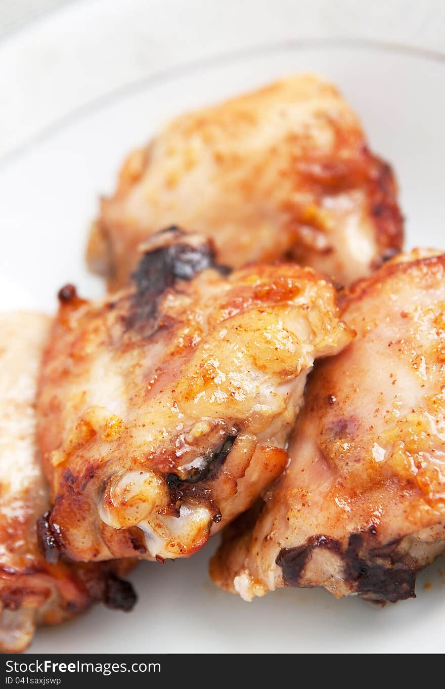 Pieces of crisp golden fried chicken on a plate ready for serving, close-up.