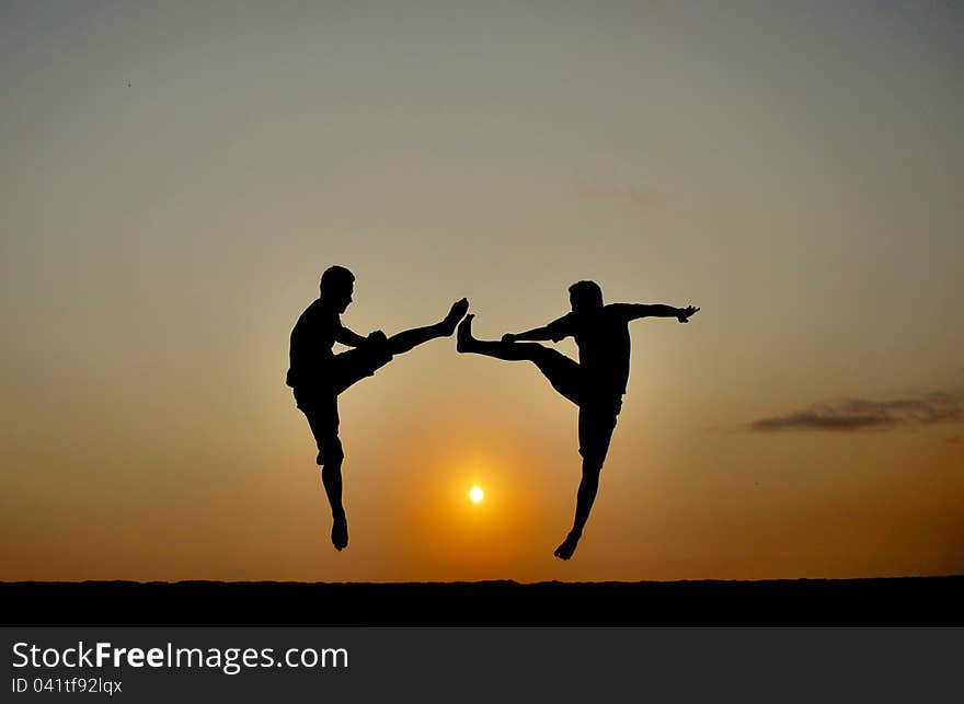 Two Teenagers Practices Kick Boxing On Sunrise