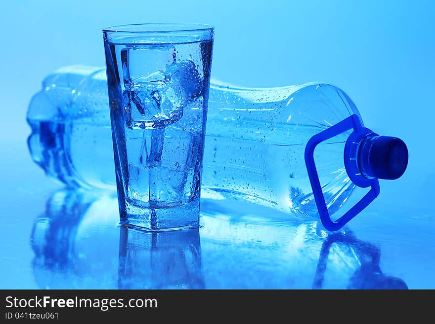 Crystal clear water with ice over blue background