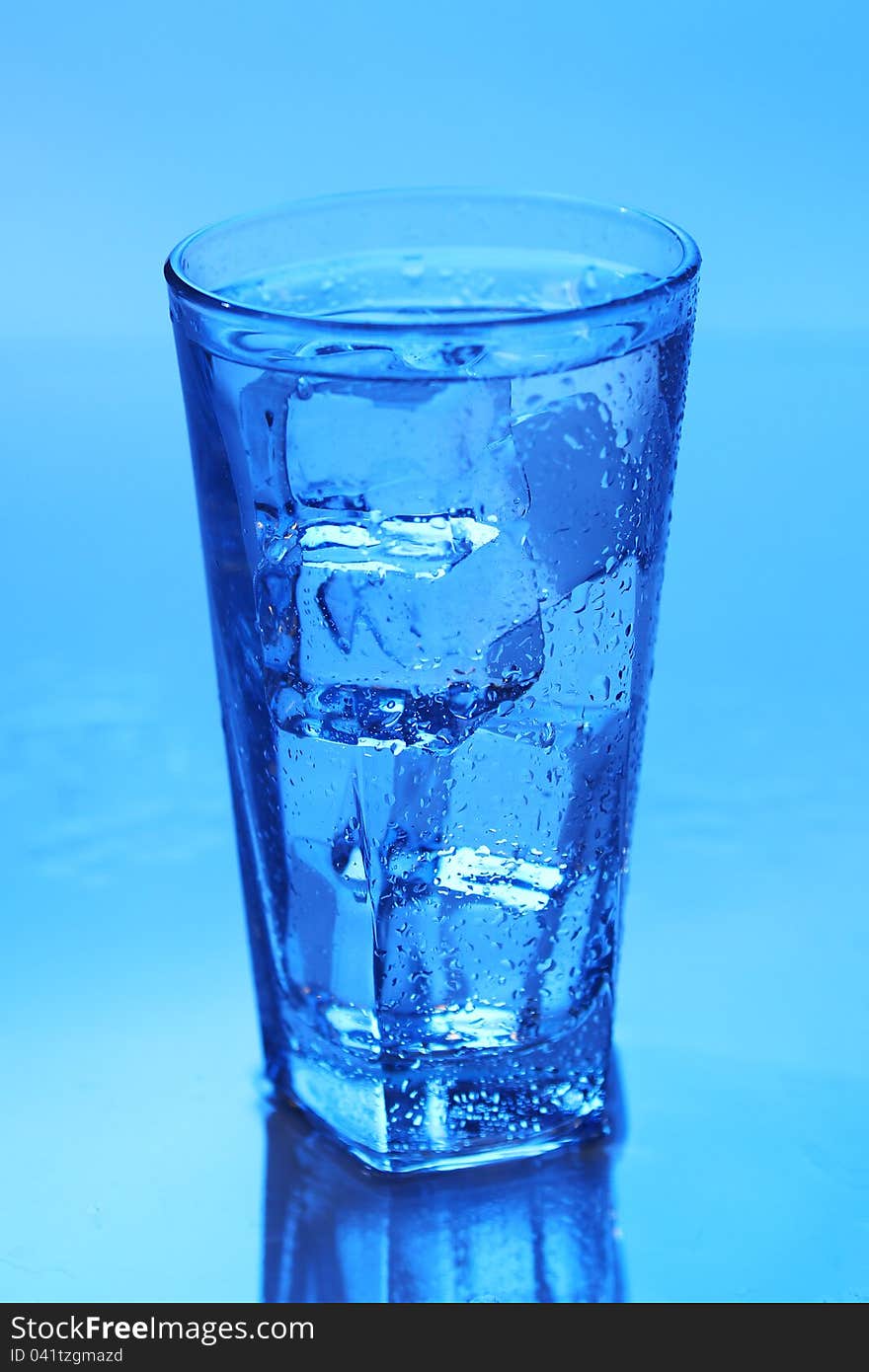 Crystal clear water with ice over blue background