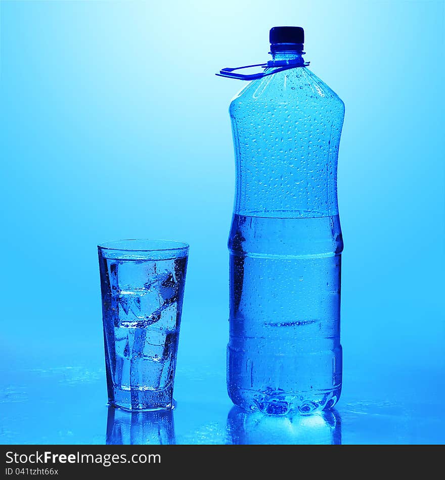 Crystal clear water with ice over blue background