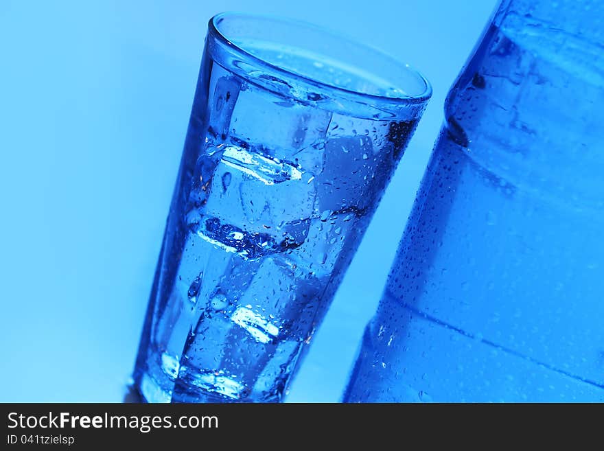 Crystal clear water with ice over blue background