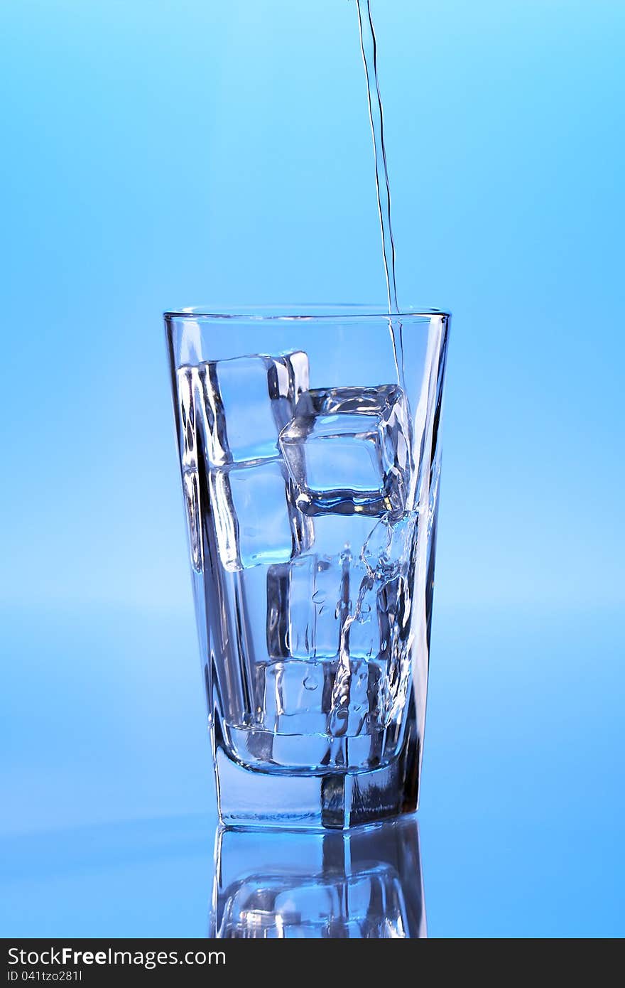 Crystal clear water with ice over blue background