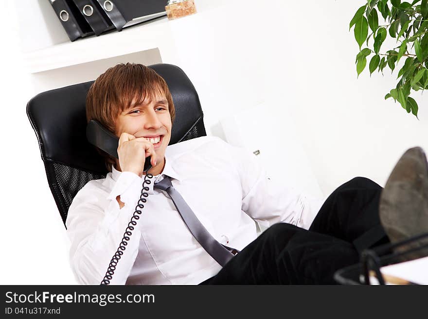 Young and successful businessman talking by phone