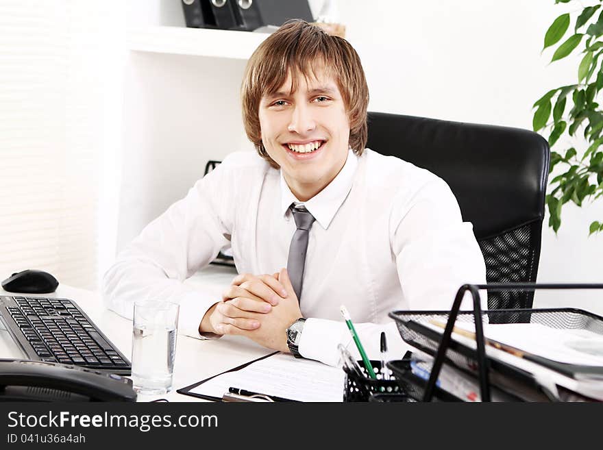 Young and successful businessman in his office