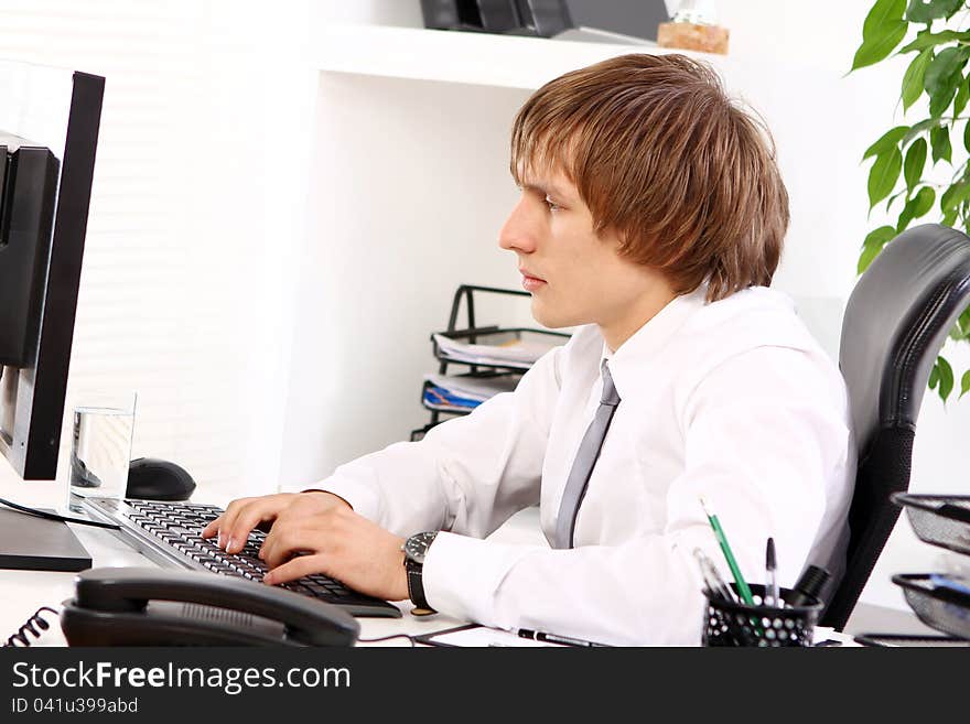 Young businessman thinking in his office. Young businessman thinking in his office