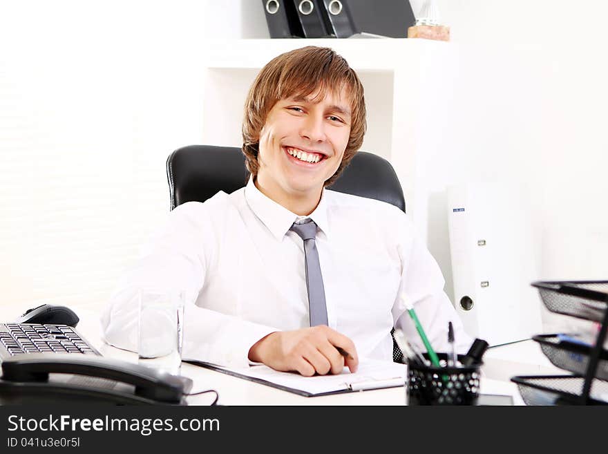 Young and successful businessman in his office