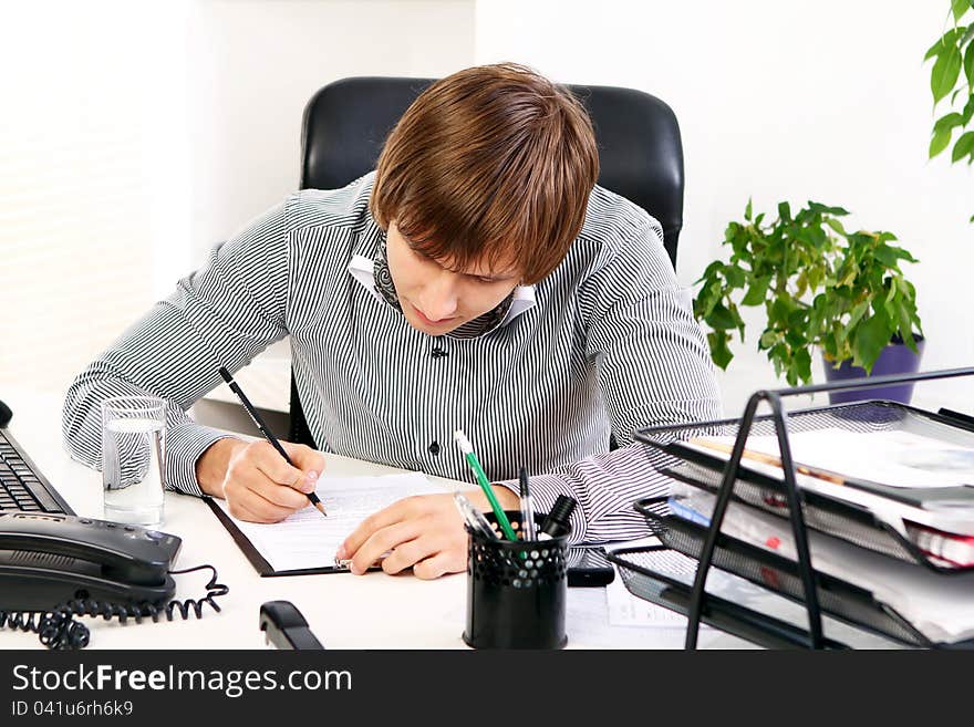 Young and successful businessman in his office. Young and successful businessman in his office