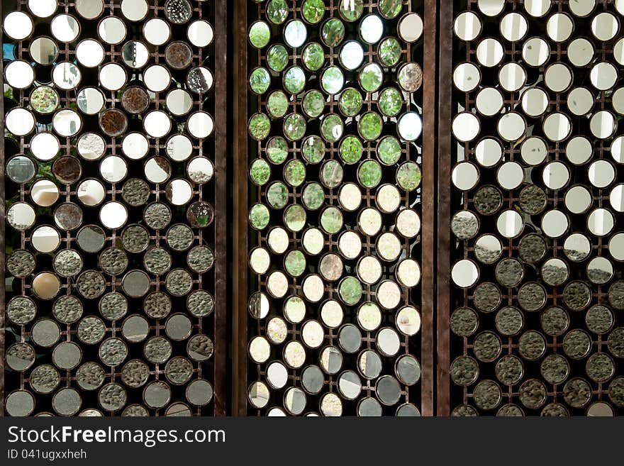 Many round mirrors on wood partition