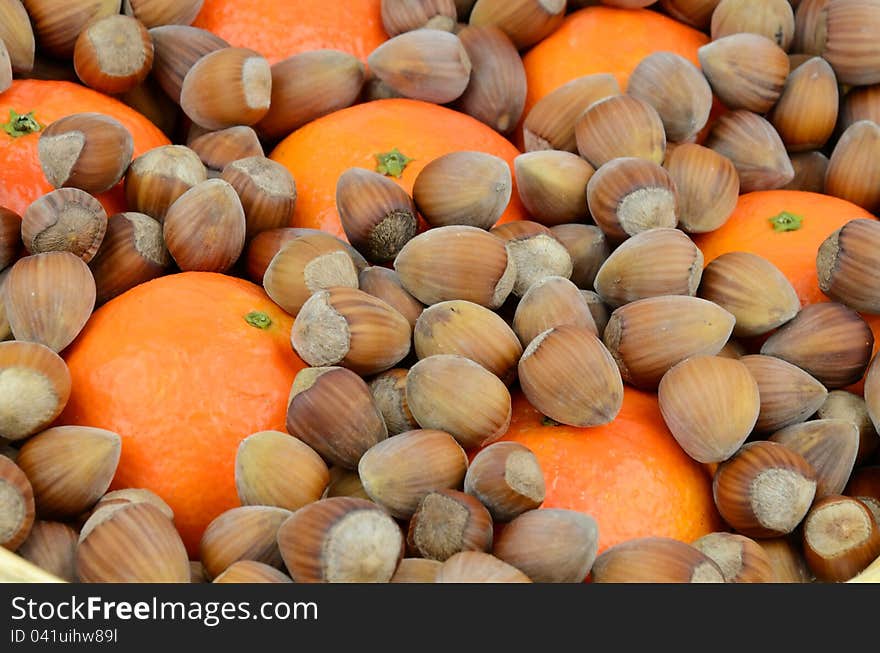 Closeup for hazelnuts and mandarins. Closeup for hazelnuts and mandarins