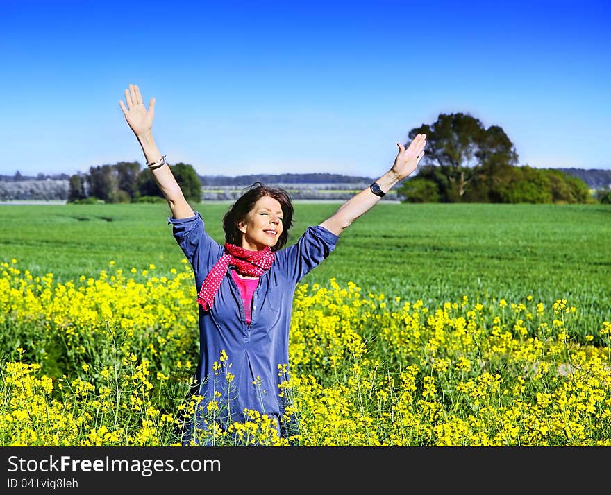 Happy woman in a rape field