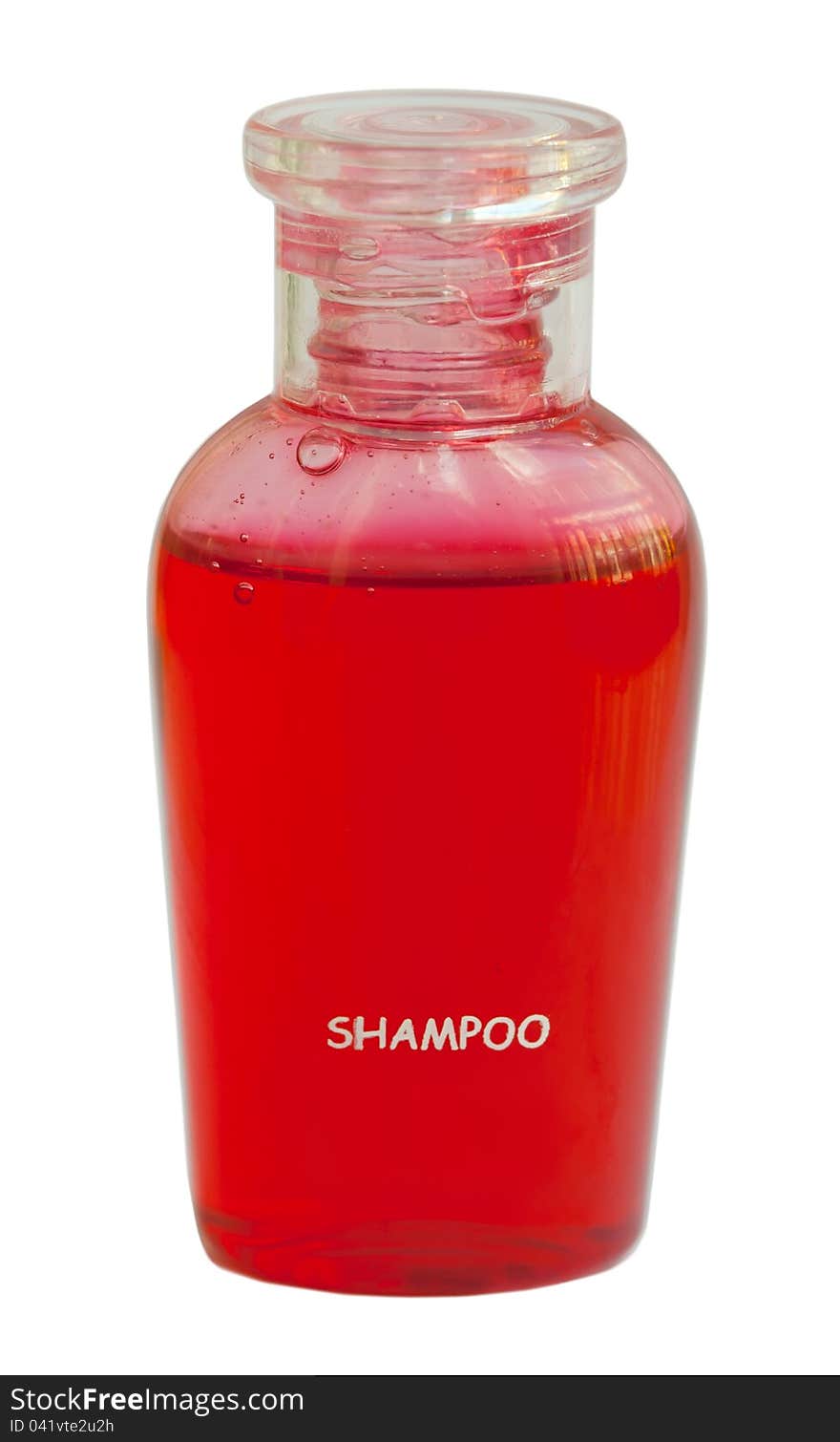 Small red bottle of shampoo isolated on white background